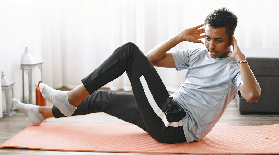 handsome-man-doing-abs-exercises-home-concept-healthy-life 1