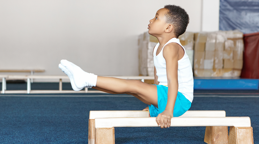 side-view-strong-flexible-dark-skinned-male-child-sportswear-doing-exercises-wooden 1